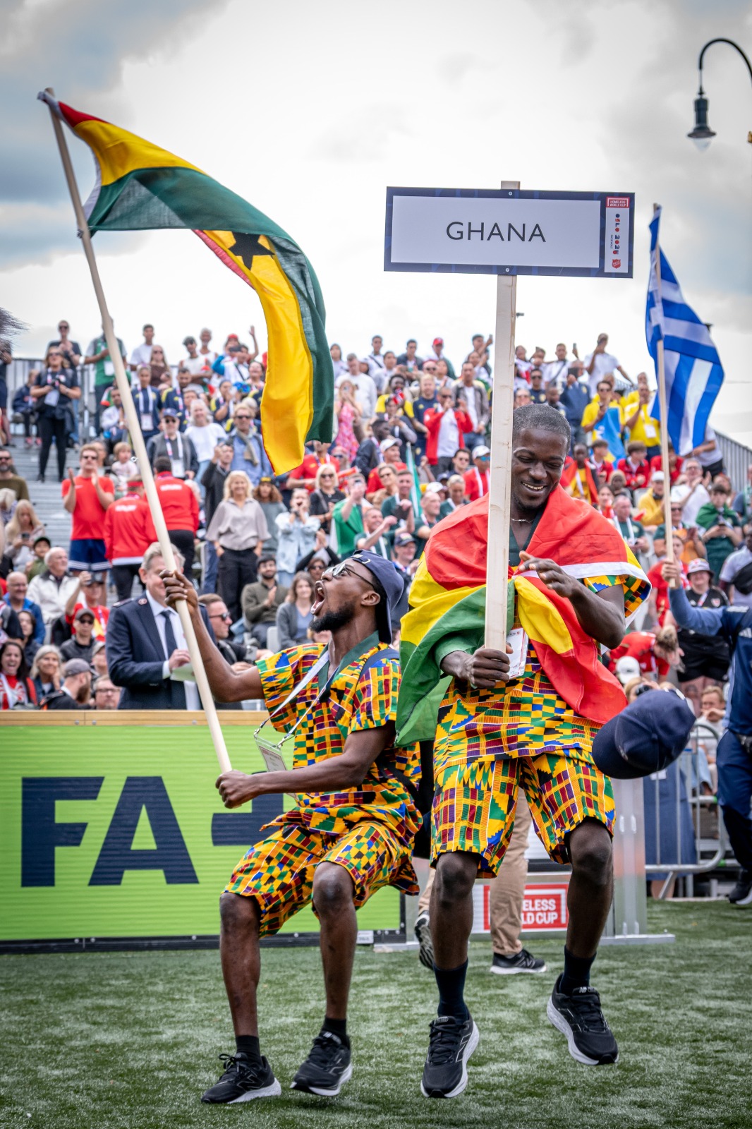 Ghana delegation celebrate holding the national flag at the Homeless World Cup