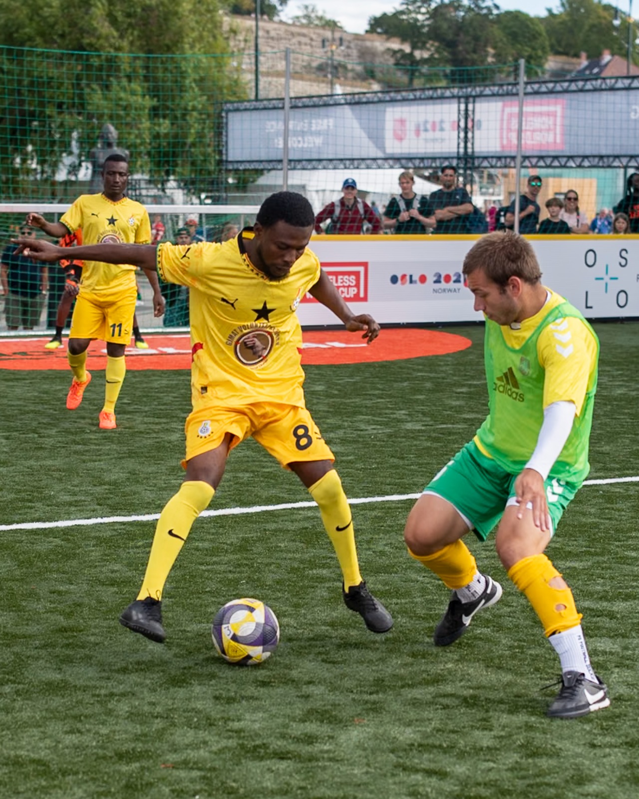 Player wearing a GIMAT Volunteer Network jersey competes at the Homeless World Cup