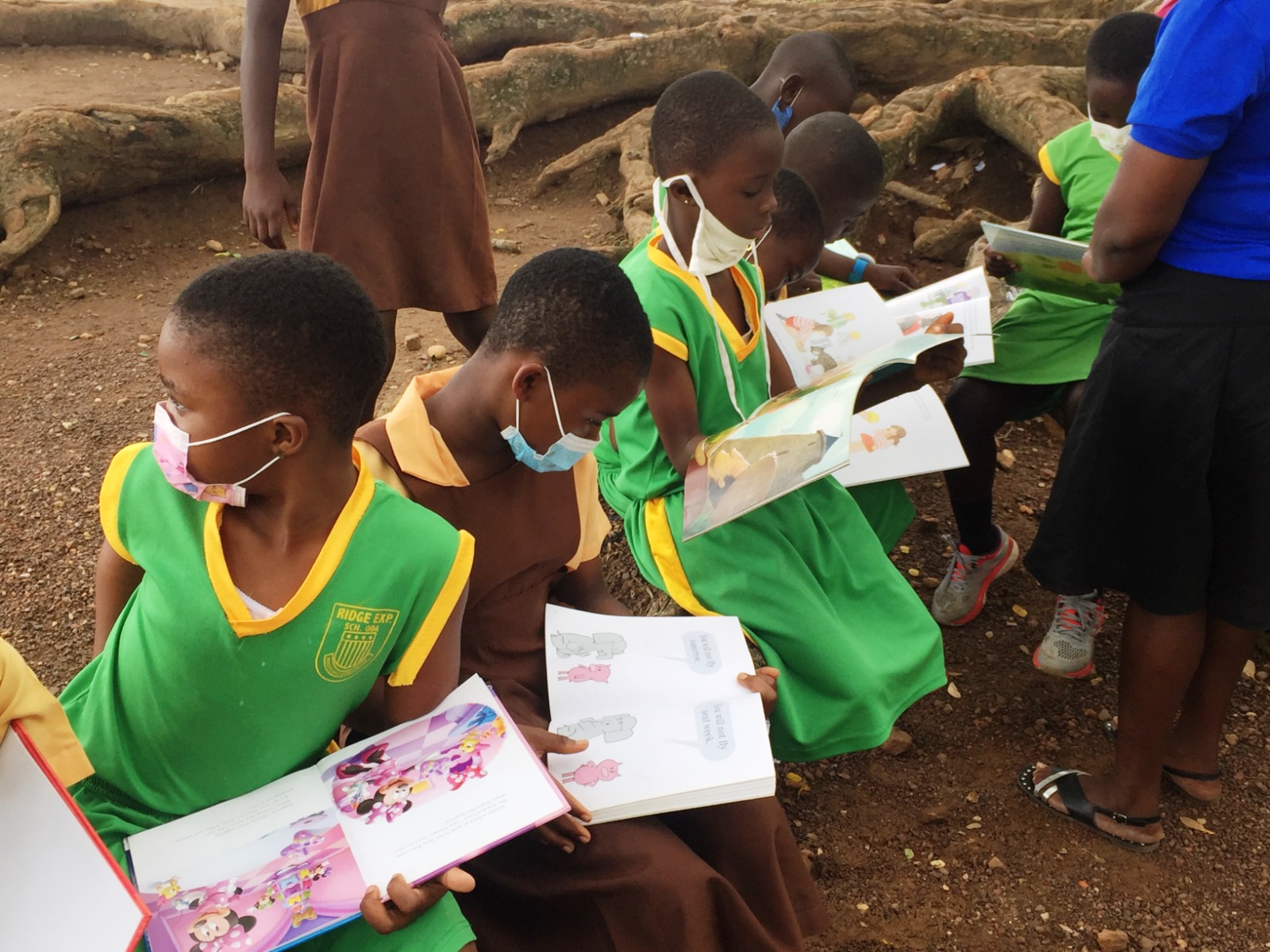 Children reading in an outdoor circle