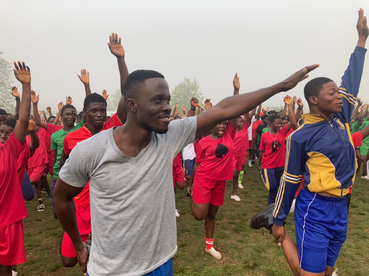 Youth stretch and train together in a field session