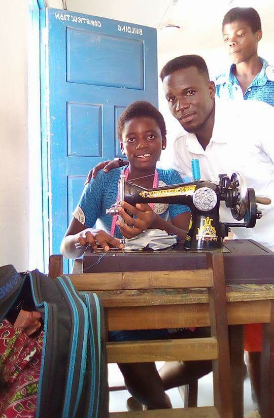 Youth learning tailoring on a sewing machine