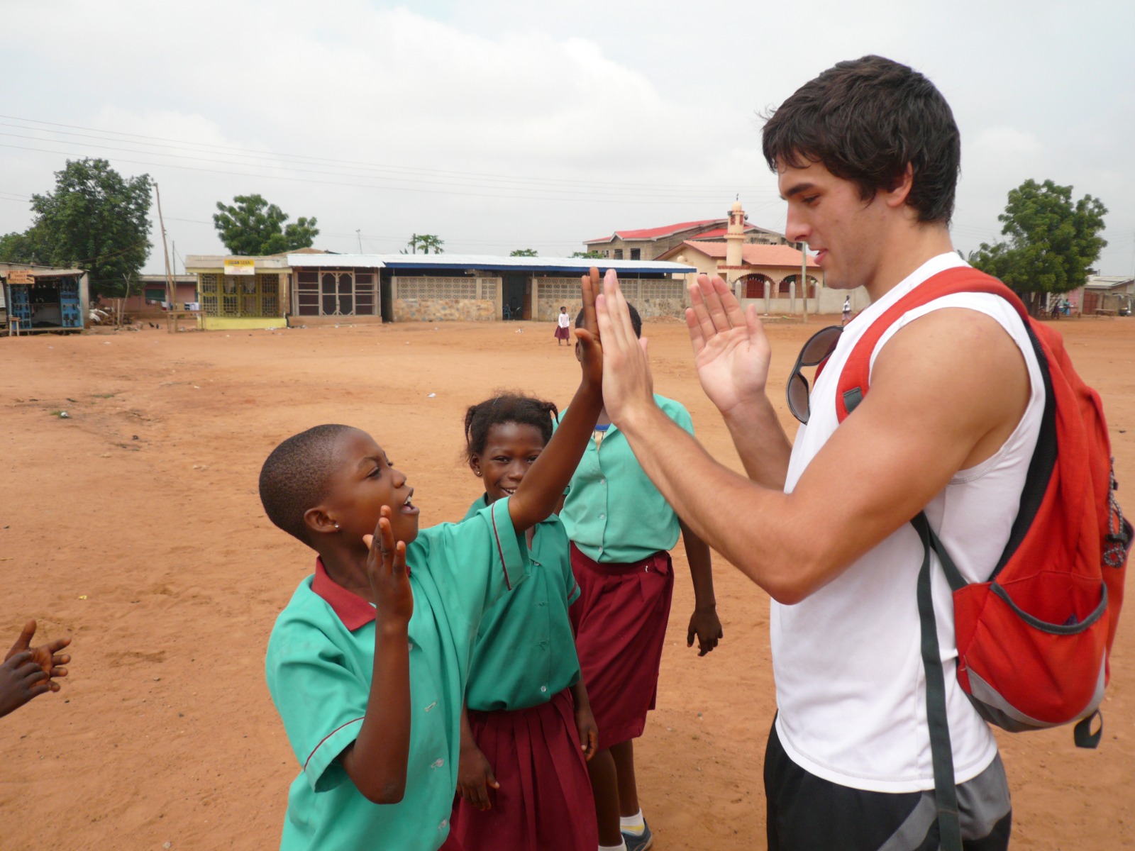 A GVN volunteer high-fives school children in Ghana