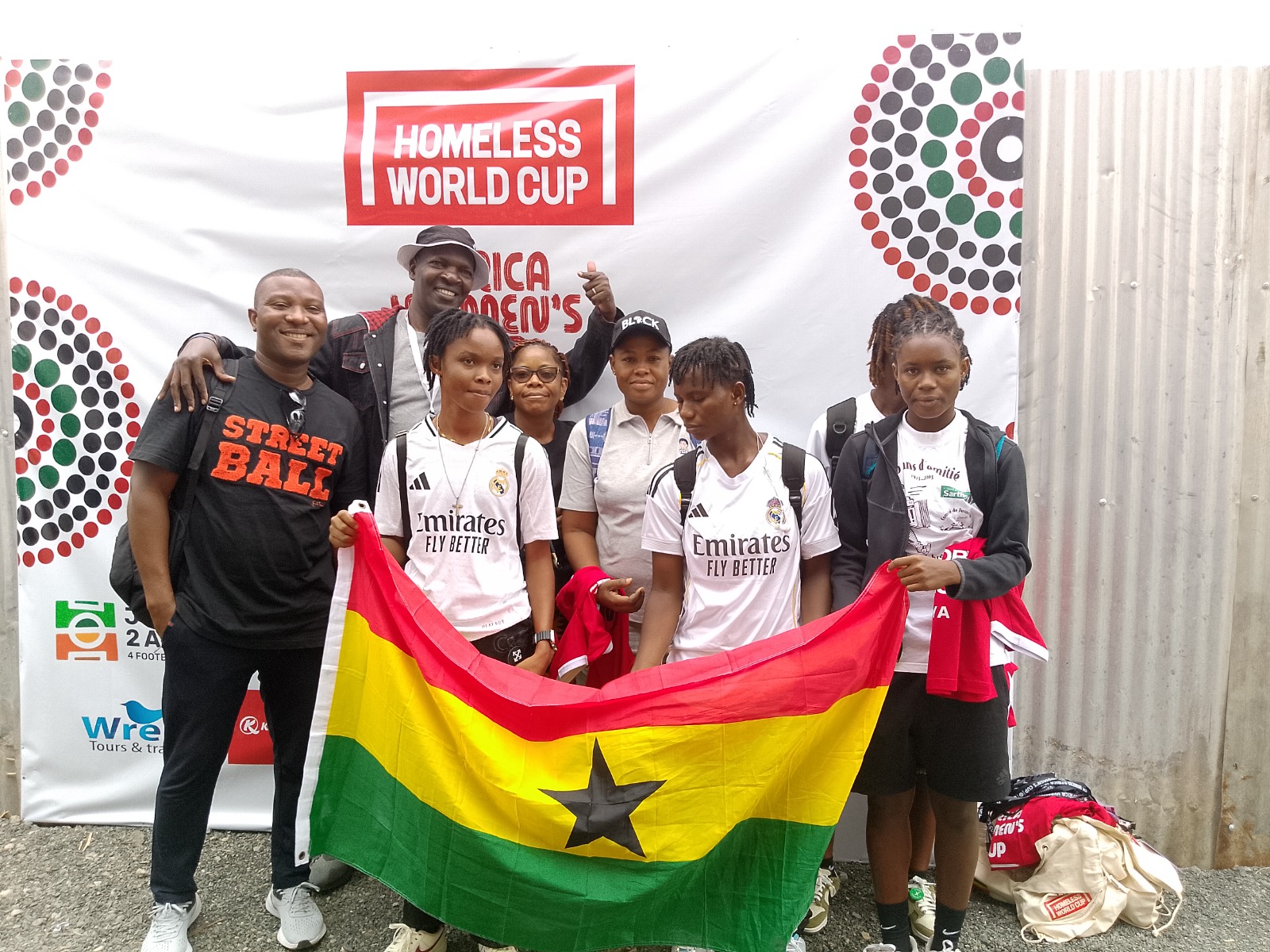 Team delegation holding the Ghana flag at the Africa Women's Cup